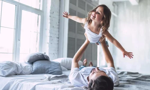 Storie_HP_web_1400x933_iStock-956005062 Papà solleva in aria la sua bambina.